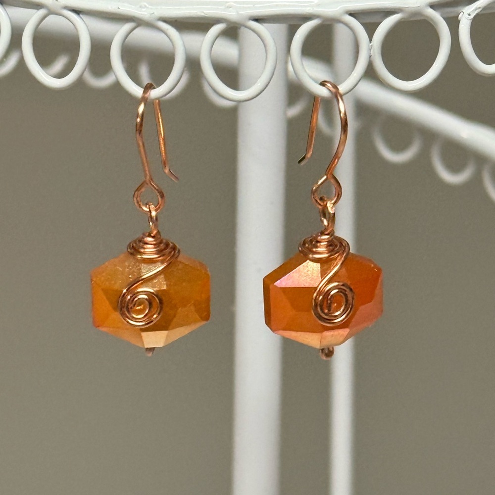 Copper Wire-Wrapped Orange Faceted Hexagon Earrings.